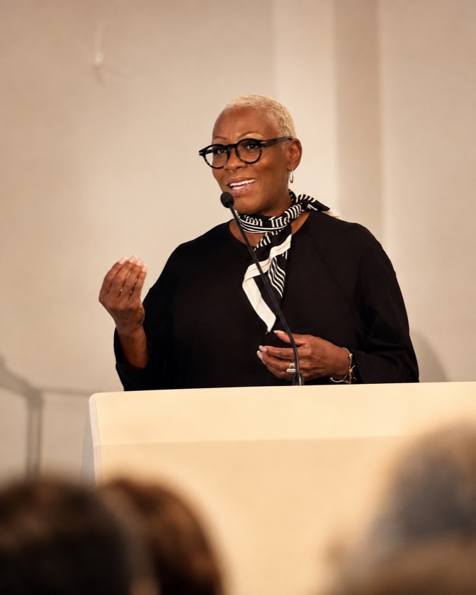 A speaker addressing an audience from a podium